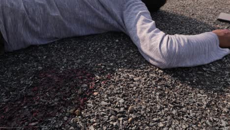 Crime-or-murder-scene-concept,-showing-of-dead-body-with-bloody-knife-with-the-body-on-roadside