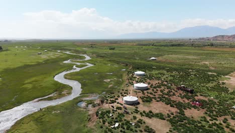 Aerial-Flyover-small-Mongolian-village-with-river-running-through