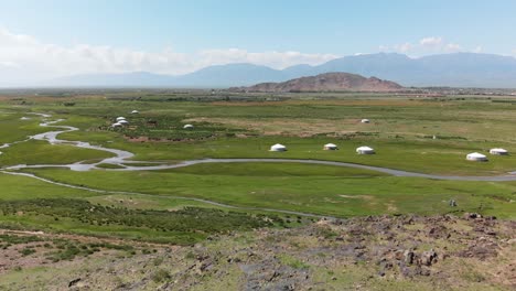 Aerial-flyover-gorgeous-green-Mongolian-countryside-with-yurts-and-streams
