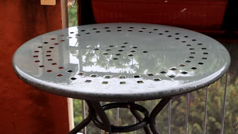 A-metallic-garden-table-under-the-rain-in-Bologna
