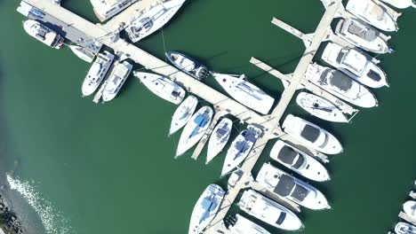 Spinning-above-the-marina-in-a-slow-pan-sweep-revealing-the-walkway-and-slips-that-boats-are-parked-in