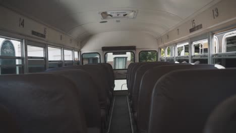 Empty-school-bus-aisle-during-daytime