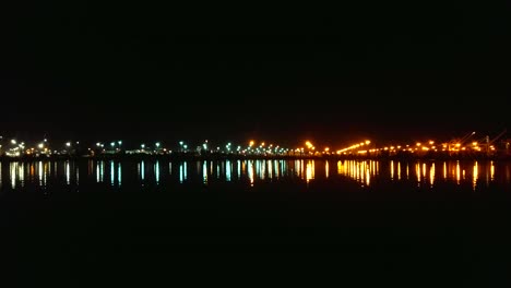 The-waves-gently-sway-as-the-harbor-lights-reflect-across-the-bay