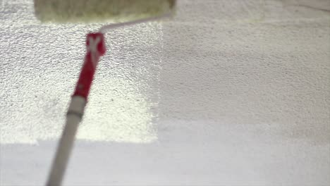 Painting-a-white-wall-with-a-roller-with-white-paint-and-giving-it-a-clean-fresh-look