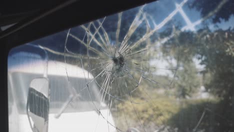 Close-up-of-broken-bus-window