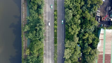 bird-eye-view-of-a-highway-with-a-river-and-trees