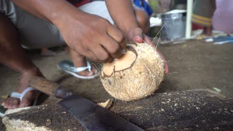 Man-Breaking-Open-Coconut-with-Machete