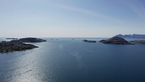 Beautiful-coastal-scenery-of-Greenland-from-drone-over-water-flying-toward-open-ocean