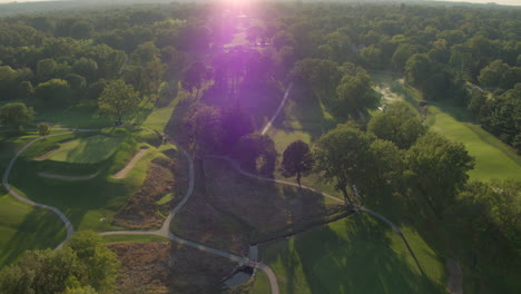 Aerial-pull-away-over-a-beautiful-golf-course-at-sunset