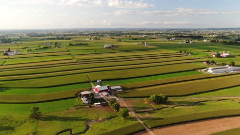 High-aerial-180-degree-pan-of-Lancaster-County-farmland-during-summer-magic-hour