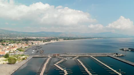 Aerial,-large-empty-marina-with-misaligned-pontoons,-Marina-di-Riposto,-Italy