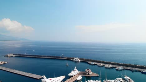 Aerial,-Marina-di-Riposto-full-of-luxury-yachts-on-calm-morning,-pedestal-down-wide-shot