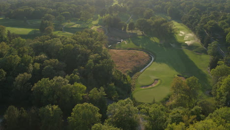 Aerial-flyover-a-beautiful-golf-course-at-sunset