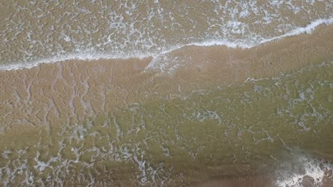 Aerial-view-of-small-waves-of-the-Baltic-Sea-and-sand-under-water