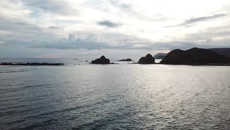 AERIAL-4K-Drone-Flying-out-to-Ocean-Rocks-in-Indonesia