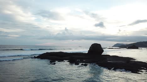 AERIAL-4K-Panning-Shot-of-Jagged-Ocean-Rocks-at-Sunset-2