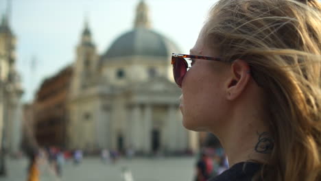 Caucasian-woman-sightseeing-in-ancient-European-city-square,-close-up-slow-motion