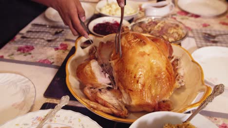 Thanksgiving-turkey-carving-on-a-table:-cutting-the-leg-in-slow-motion-4K