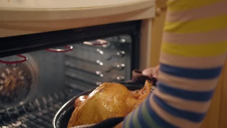 Placing-an-uncooked-Thanksgiving-turkey-into-an-oven-in-slow-motion-4K