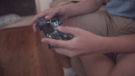 A-young-boy-plays-video-games-with-a-controller-
