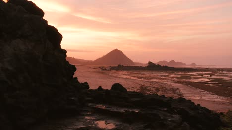The-dry-reef-of-Kuta-Lombok-during-sunrise,-with-local-people-looking-for-food-and-seashells