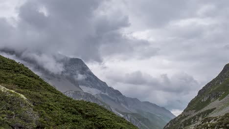 Time-lapse-footage-of-grey-swirling-clouds-gathering-around-a-high-alpine-mountain-peak-in-eastern-Alps-of-Switzerland