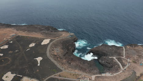 Atlantic-coast-on-Sal-Island,-Cape-Verde,-volcanic-stone-contrasting-with-the-Atlantic-Ocean