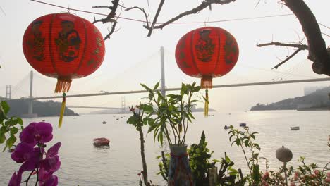 Red-Lanterns-hang-in-foreground-with-Ocean-and-Bridges-as-background