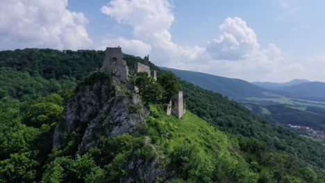 Flight-close-to-abandoned-medieval-ruined-Plavecky-Castle-on-a-rock,-Slovakia