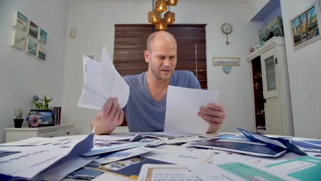 Frustrated-bald-Man-Seating-at-Home-and-thinking-how-to-pay-his-bills