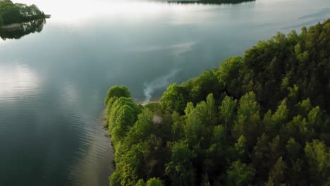 Aerial-view-of-grill-smoke-at-the-shore-of-wdzydze-lake-in-Poland