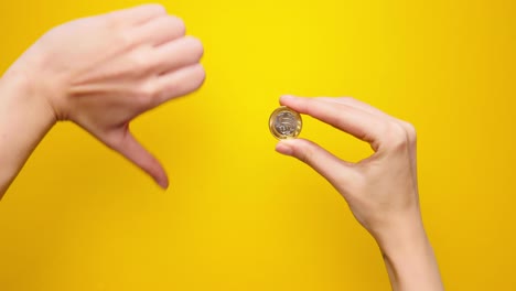 Woman-hand-shows-Brazilian-coin-thumbs-up-gesture