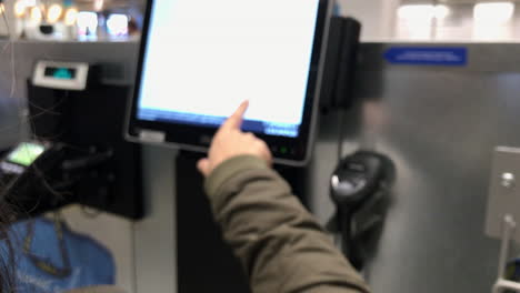 Blurred:-A-woman-operates-a-self-service-cash-register-panel