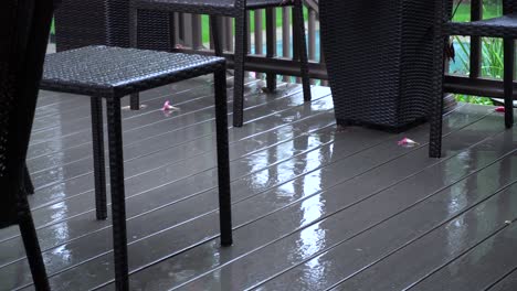 Light-pattering-of-rain-onto-a-deck-at-the-end-of-summer
