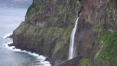 Slow-Motion-footage-of-a-big-waterfall-falling-from-a-cliff-into-the-ocean
