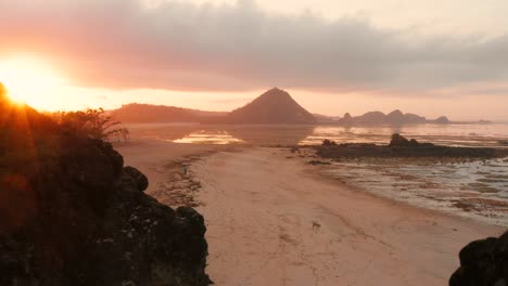 The-dry-reef-of-Kuta-Lombok-during-sunrise,-with-local-people-looking-for-food-and-seashells