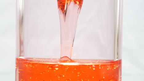 Close-up-of-viscous-red-liquid-in-hourglass