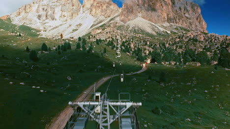 Flight-along-the-cables-of-the-Sassolungo---Langkofel-cable-railway-bringing-hikers-and-other-tourists-on-the-top-of-the-mountain