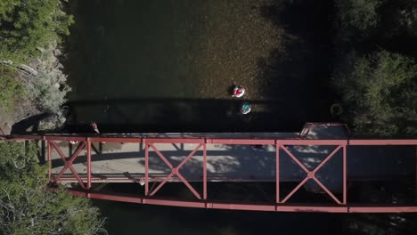 Aerial-view-person-jumping-off-bridge-into-Boise-river