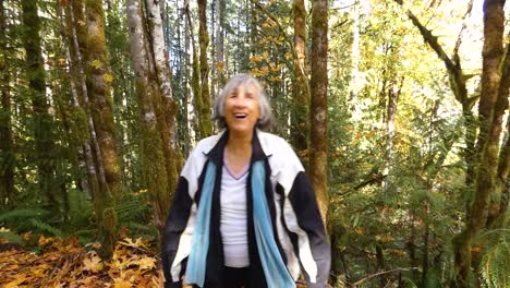 woman-throwing-leaves-in-the-air-on-foot-path-in-Canada-in-autumn-in-slow-motion