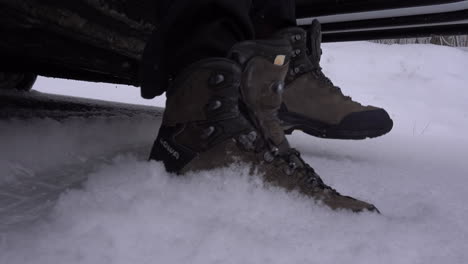 Shoes-close-shot-of-man-going-out-of-car-in-first-snow