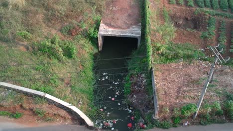 Aerial-drone-shot-of-polluted-stagnant-sewer-or-river-full-of-trash