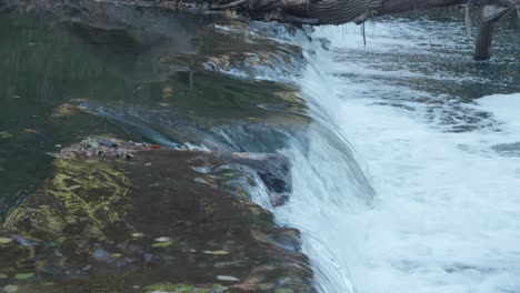 Calm-waters-of-the-Wissahickon-Creek,-waterfall