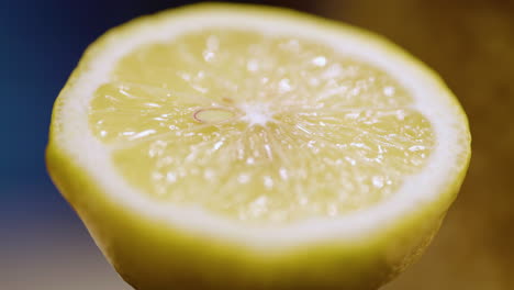 Macro-close-up-of-a-sliced-lemon-slowly-rotating-counter-clockwise
