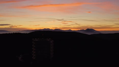 Sunset-above-mountains-and-lookout-tower-in-front,-Rogla,-Pohorje,-Slovenia-recreational-retreat