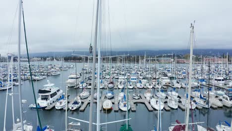 Sail-boats-in-their-slips-in-a-Marina-on-a-cloudy-day-with-slight-rain