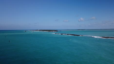 Beautiful-tiny-islands-in-the-Bahamas-as-turquoise-water-of-the-Caribbean-washes-onto-white-sand-and-rocks