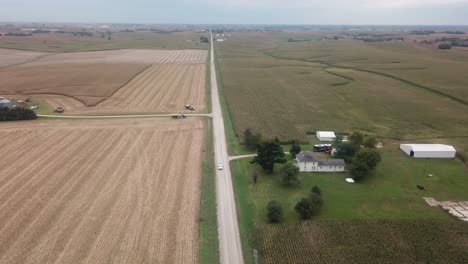 Aerial-view-of-truck-driving-on-a-gravel-road-in-rural-Iowa