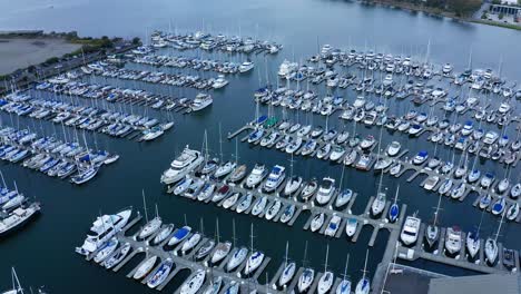 Sailboats-in-their-slips-in-a-marina-and-a-port-shipping-and-luxury