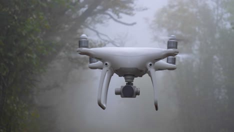 A-drone-hovers-in-flight-on-a-misty-foggy-autumn-forest-path